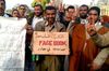 A man holds a handmade Facebook sign