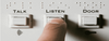 Three buttons, labelled talk, listen, door, including in braille. A finger hovers over 'listen'